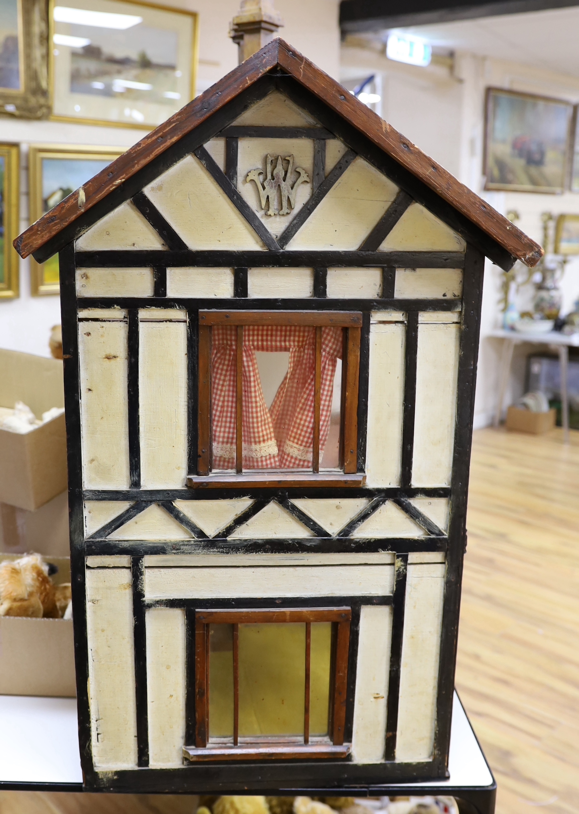 A large furnished English doll's house, circa 1900, presented as William Wordsworth's two floor Tudor-beamed cottage, 119cm x 103cm x 53cm